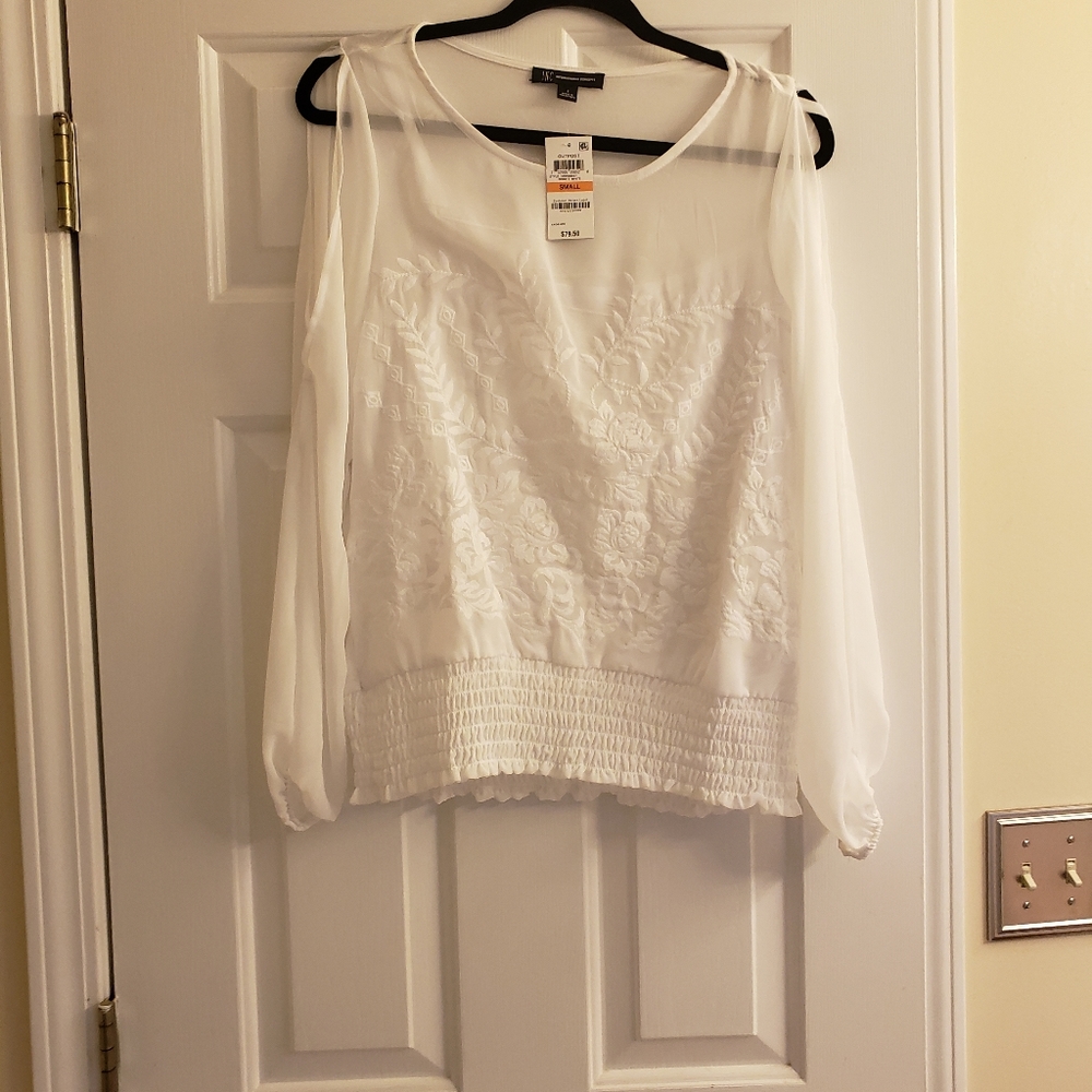 Pretty white, sheer and cut out sleeve blouse.